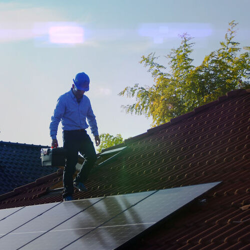 A roofer inspects a roof.