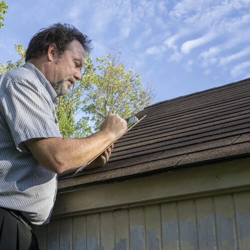Roofer inspects a roof.